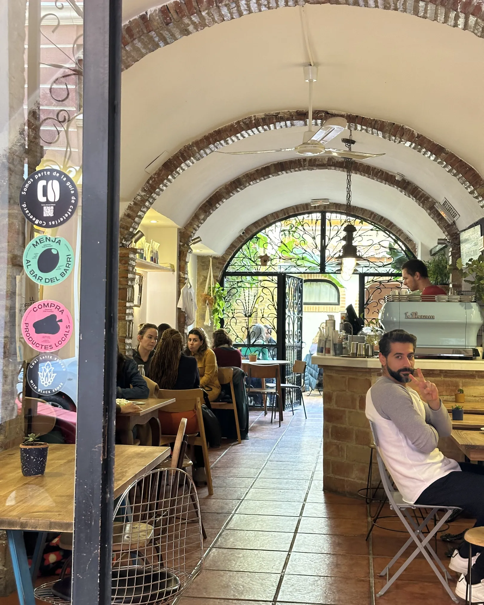Catalan vaulted brick ceilings above tables of customers at Bluebell Coffee Roasters, Ruzafa, Valencia