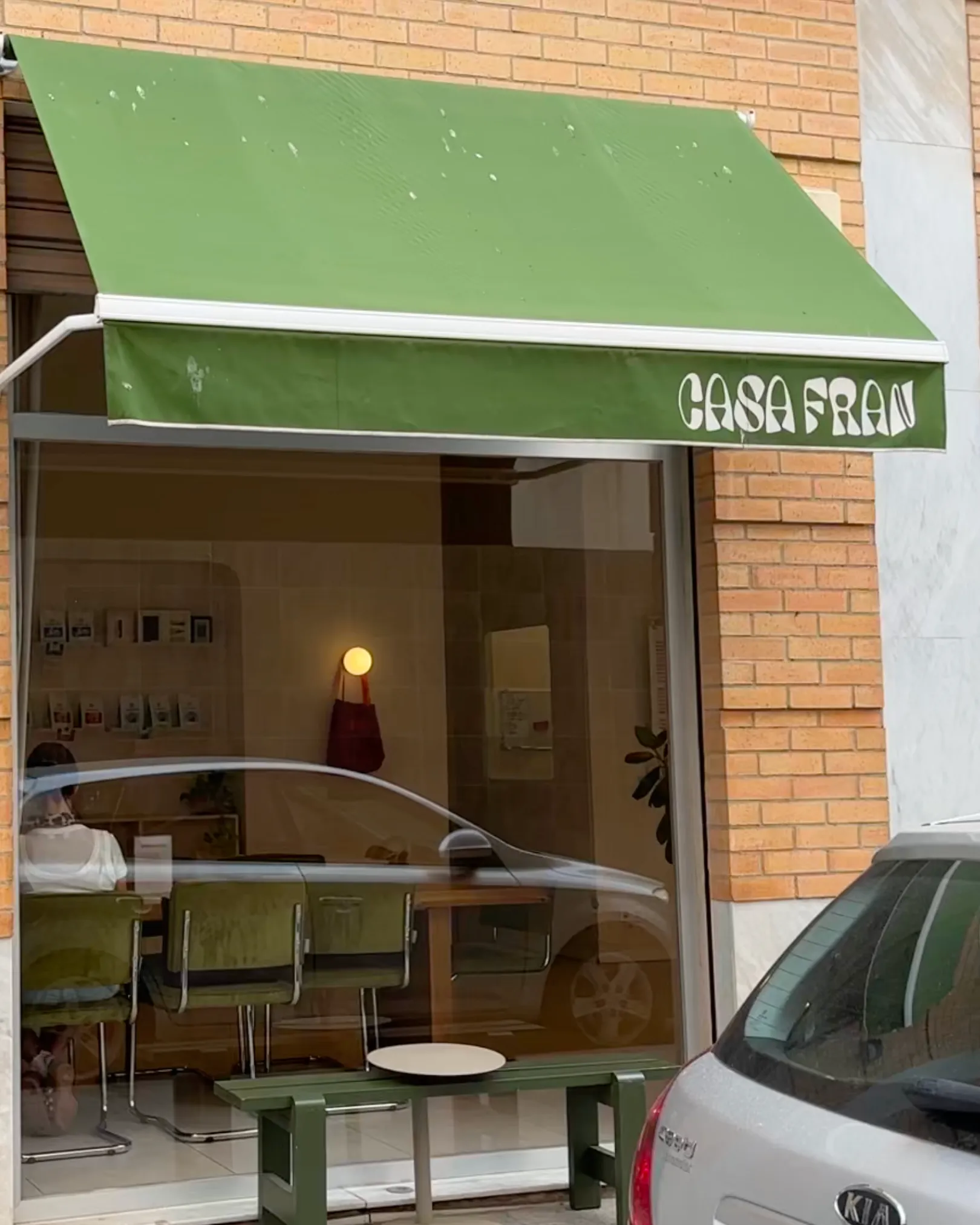 Green awning with the Casa Fran name above the cafe window in El Carmen, Valencia